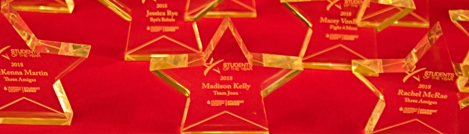 2018 Student of the Year participation awards in the shape of clear stars sit on a red table cloth